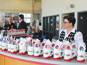 Drayton Valley Toyota/Scion finance manager Carolin Charron was busy greeting customers with a smile and giveaways during the dealership's grand opening July 29.