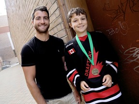 Calgary Flames T.J. Brodie, left, and Declan Waddick, who brought home the gold for Canada during the Warrior Elite European Cup in Prague, Czech Republic, were special guests at the Rotary of Chatham luncheon meeting. Brodie spent several minutes answering questions during the informal Q&A event. Photo taken in Chatham, Ont. on Wednesday August 5, 2015. (Diana Martin/Chatham Daily News/Postmedia Network)