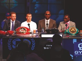 Former Canadian boxer Lennox Lewis (centre) was in Toronto to announce the coming title fight between Adonis Stevenson (right) and Tommy Karpency. (JACK BOLAND/Toronto Sun)