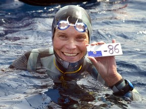 A file photo taken on September 3, 2005 shows Russian Natalia Molchanova holding the minus 86 metres tag that gives her a win in the first women's free-diving world championship in Villefranche-sur-Mer. Molchanova, 53, has been reported missing since August 2, 2015 following a fun dive off the coast of Formentera and the search has been called off. AFP PHOTO JACQUES MUNCH
