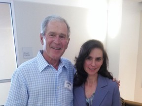 In this photo provided by Terrell Eustice, Eustice, right, poses for a photo with former President George W. Bush who showed up for jury duty in Dallas, Wednesday, Aug. 5, 2015. The 43rd president was not chosen for a jury but did have his picture taken with people before leaving after a few hours. (Courtesy of Terrell Eustice via AP)