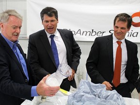 BioAmber executives Mike Hartmann, centre, and Jean Francois Huc, right, show Sarnia Mayor Mike Bradley a container of the company's bio-succinic acid. BioAmber held a plant opening ceremony at its recently built Sarnia facility Thursday. Tyler Kula/Sarnia Observer/Postmedia Network