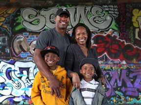 Ottawa RedBlack's quarterback Henry Burris, his wife Nicole and two boys Armand and Barron pose for a photo in Ottawa. (Tony Caldwell Ottawa Sun/Postmedia Network)