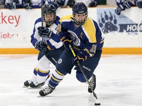 Laurentian Voyageurs captain Julie Hebert eludes a Ryerson Rams player during OUA women's hockey action in Sudbury last season. Hebert will rejoin Laurentian for her final year of eligibility in 2015-16. John Lappa/The Sudbury Star/Postmedia Network