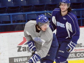 Sudbury Wolves forwards Danny Desrochers (front) and Jacob Harris enjoy a light-hearted game of keepaway late in a team practice. The 20-year-olds are among Sudbury's better overage options for 2015-16. Bruce Heidman/The Sudbury Star/Postmedia Network