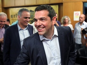 Greek Prime Minister Alexis Tsipras smiles as he greets people at the Agriculture Ministry in central Athens, Greece, August 5, 2015. REUTERS/Yiannis Kourtoglou