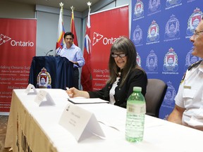 Yasir Naqvi, Ontario's minister of community safety and correctional services, along with Kingston and the Islands MPP Sophie Kiwala and Kingston Police Chief Gilles Larochelle, announces close to $139,000 in funding for two programs to help police better reach at-risk citizens. (Elliot Ferguson/The Whig-Standard)