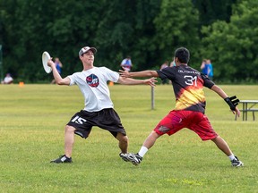 General Strike's Al Scarth gets ready to throw the disc around a teammate during a recent team practice for CUC Winnipeg 2015.