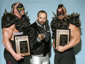 Legendary tag-team wrestlers Hawk, left, and Animal, right, are flanked by longtime manager Paul Ellering. 
Courtesy of The Wrestling Revue Archives, www.wrestlingrevue.com