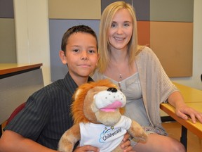 Ottawa - Aug 6, 2015 - On Thursday, Aug. 6 2015, Gabo Munante, 9, received confirmation of his trip to Legoland, CA paid for by the Children's Wish Foundation. He was diagnosed with cancer three years ago. Lisa Stinson, right, knows the feeling. As a cancer survivor, she was touched by the foundation nearly a decade ago when she and her family went on a trip to The Bahamas. (Sam Cooley /Ottawa Sun/Postmedia Network)