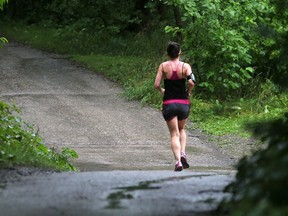 An unidentified woman jogs in Assiniboine Park near the English Garden August 5, 2015. A creep has been luring women with claims of a lost wallet.