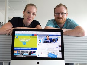 Goodwill Industries marketing co-ordinator Kayleigh Walters and marketing manager Craig Huffman are among the people who answer questions and comments posted to the Goodwill Facebook page, seen Thursday on the screen in front of them. (DEREK RUTTAN, The London Free Press)