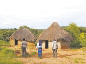 Rural residents of Zambia walk toward grass-roofed houses like the ones Pastor Jamie Greenwood visited on his recent trip to the Southern African nation. (Darrin Zammit Lupi /Reuters)