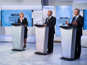 Liberal leader Justin Trudeau, Green Party leader Elizabeth May and New Democratic Party leader Thomas Mulcair listen as  Conservative Leader Stephen Harper speaks during the first leaders' debate Thursday, August 6, 2015 in Toronto. THE CANADIAN PRESS/Frank Gunn