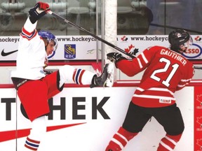 Team Canada’s Julien Gauthier battles Czech Republic’s Ondrej Miklis during first-period action at the world junior summer development camp last night. (Darren Makowichuk/postmedia network)