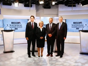 Liberal leader Justin Trudeau, left, Green Party leader Elizabeth May, second from left, New Democratic Party (NDP) leader Thomas Mulcair; and Conservative Prime Minister Stephen Harper, right, pose ahead of the Maclean's National Leaders debate in Toronto, Aug. 6, 2015.  AFP PHOTO / Pool / MARCK BLINCH