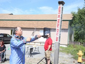 Local artist and educator Will Morin conducts a smudging ceremony in Sudbury, Ont. on Thursday, Aug. 6, 2015, at the dedication of the peace pole in Wahnapitae. Gino Donato/The Sudbury Star/Postmedia Network