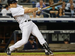 New York Yankees' Mark Teixeira swings on a sixth-inning single that scored Chris Young in a baseball game against the Boston Red Sox at Yankee Stadium in New York, Tuesday, Aug. 4, 2015. (AP Photo/Kathy Willens)