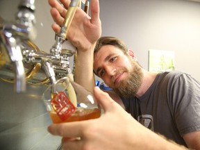 Michael Guillemette, the brewmaster at Stack Brewing pours a Stack '72 in Sudbury, Ont. in this file photo.