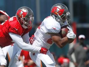 Tampa Bay Buccaneers defender Danny Lansanah can’t stop running back Doug Martin, right, during training camp in Tampa, Fla. Thursday, Aug. 6, 2015. (James Borchuck/The Tampa Bay Times via AP)