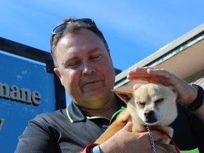 SAMANTHA REED/FOR THE INTELLIGENCER
Ian Stock, member of 100 Men Who Care Quinte, holds Mickey the Chihuahua outside of The Quinte Humane Society Friday morning. The 100 Men group donated nearly $10,000 to the shelter. Mickey, along with many other animals are up for adoption at the shelter.