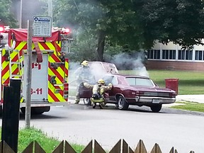 Submitted photo: Firefighters tend to a car fire in front of Wallaceburg District Secondary School on Friday, August 7 in the afternoon. No details about how the fire started or the extent of the damage was known on Friday.