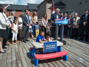 Conservative Leader Stephen Harper delivers a speech to supporters in the back yard of a suburban home in Richmond Hill, Ont., on Friday, August 7, 2015. THE CANADIAN PRESS/Paul Chiasson