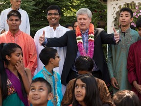 Conservative leader Stephen Harper gathers Hindu children around him for a photograph during a campaign stop Friday, August 7, 2015 in Richmond Hill, Ont. THE CANADIAN PRESS/Paul Chiasson
