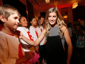 Canadian tennis star Eugenie Bouchard gets a little love from some of 'Genie's Army' after the Rogers Cup draw Friday August 7, 2015 in Toronto. (Stan Behal/Toronto Sun/Postmedia Network)