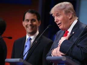 Republican presidential candidates Donald Trump (R) and Wisconsin Gov. Scott Walker participate in the first prime-time presidential debate hosted by FOX News and Facebook at the Quicken Loans Arena August 6, 2015 in Cleveland, Ohio. Chip Somodevilla/Getty Images/AFP