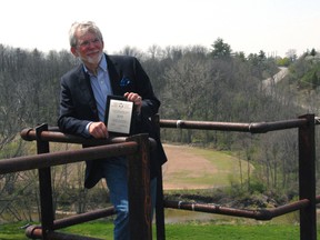 Serge Lavoie, president of On Track St. Thomas, stands atop the Michigan Central Railroad trestle in May following receipt of a $42,500 grant from the Ontario Trillium Foundation. The grant will be used to fund a master plan for the proposed elevated park project.
