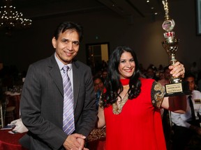 Toronto Sun Editor Adrienne Batra celebrates her Parvasi Award for Best Journalist this evening in Brampton with organizer Rajinder Saini, President of Parvasi Media Group on Aug. 7, 2015. (Stan Behal/Toronto Sun)