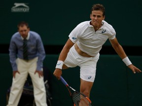 Vasek Pospisil of Canada returns a shot to Andy Murray of Britain, during their singles match at the All England Lawn Tennis Championships in Wimbledon on July 8, 2015. (AP Photo/Alastair Grant)