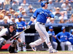 Justin Smoak of the Toronto Blue Jays hits a grand slam in the sixth inning as Brian McCann of the New York Yankees defends on August 8, 2015 at Yankee Stadium. (Elsa/Getty Images/AFP)