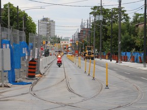 A rider makes his way northbound on Leslie St., towards Queen St. E., as the stretch of road re-opened on Aug. 8, 2015 -- nearly two years after it was closed for water main and streetcar track installation. (Nick Westoll/Toronto Sun)