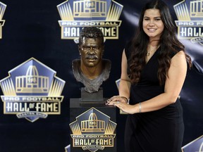 Sydney Seau poses with the bust of her late father Junior Seau at the 2015 Pro Football Enshrinement Cermony at Tom Benson Hall of Fame Stadium. (Andrew Weber-USA TODAY Sports)