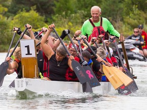Doug Mottram (green shirt) steers a Belleville team during a race at the Ninth annual Wellington Lions Dragon Boat Festival  on Saturday August 8, 2015 in Prince Edward County, Ont. Tim Miller/Belleville Intelligencer/Postmedia Network