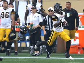 Hamilton Tiger-Cats KR Brandon Banks returns a punt for a touchdown against the Winnipeg Blue Bombers during CFL action in Winnipeg on Thu., July 2, 2015. Kevin King/Winnipeg Sun/Postmedia Network