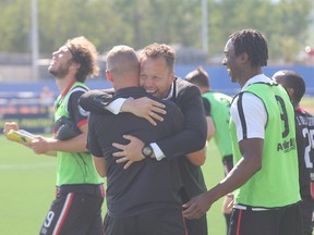 Ottawa Fury FC head coach Marc Dos Santos embraces assistant coach Martin Nash after their team's 1-0 victory over FC Edmonton in Fort McMurray Alta. on Sunday Aug. 2, 2015. (Robert Murray/Fort McMurray Today/Postmedia Network)