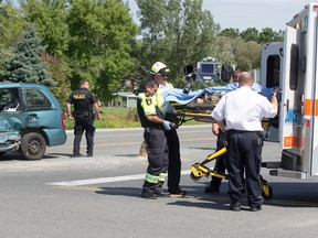 Paramedics load a victim of a two-vehicle crash into an ambulance near Grand Bend on Sunday. Ten people were taken to hospital when a pickup truck collided with a van on Hwy. 21 at Dashwood Road. Derek Ruttan/The London Free Press/Postmedia Network