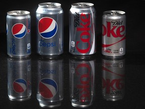 Regular and mini cans of Diet Coke and Diet Pepsi are pictured in this photo illustration in New York August 5, 2014.  REUTERS/Carlo Allegri