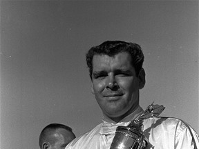 In this Feb. 9, 1969, file photo, Buddy Baker  holds a trophy presented to him after he won the pole position for the Daytona 500 Grand National stock car race at Daytona Speedway in Daytona Beach, Fla. (AP Photo/File)