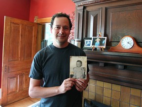 Scott Mccarthy stands in front of the mantel where he found what he believes is a photo of a baby from the 1950s.(Shaun Gregory/Huron Expositor)