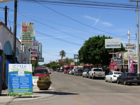 In this Thursday, April 30, 2015 photo, a street full of a dental offices is seen in Los Algodones, Mexico, which sits on the border with California. Thousands of Americans and Canadians travel to Los Algodones each year for affordable and reliable dental work from dentists who speak English and sometimes accept U.S. insurance. (AP Photo/Astrid Galván)
