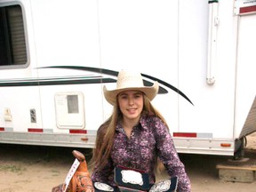 Robyn Lively, 16, with her third go round buckles and her Alberta Champion buckle and saddle for pole bending at the Alberta Finals rodeo in Grande Prairie on June 5-7, 2015.