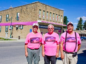 Ken Neumann, Dick Burnham and Charlie Price of the Elks in front of the ‘pink-i-fied’ legion.