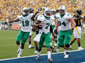 Travon Van #7 of the Marshall Thundering Herd celebrates after rushing for a touchdown against the West Virginia Mountaineers during the game on September 1, 2012 at Mountaineer Field in Morgantown, West Virginia.  
AFP photo