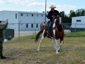 SUBMITTED PHOTO
Paul Nichols meets a soldier during a ride through CFB Shilo on July 6. Paul is coming to Trenton and Prince Edward County this month as part of his cross-country trek on horseback, to support veterans and their families.