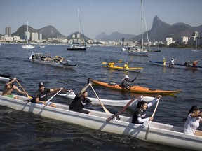 People row their boats as part of a protest against the polluted waters of Guanabara bay in Rio de Janeiro, Brazil on Aug. 8, 2015. (AP Photo/Leo Correa)