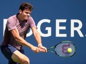 Milos Raonic hits a backhand during practice session at Uniprix Stadium. (Eric Bolte-USA TODAY Sports)